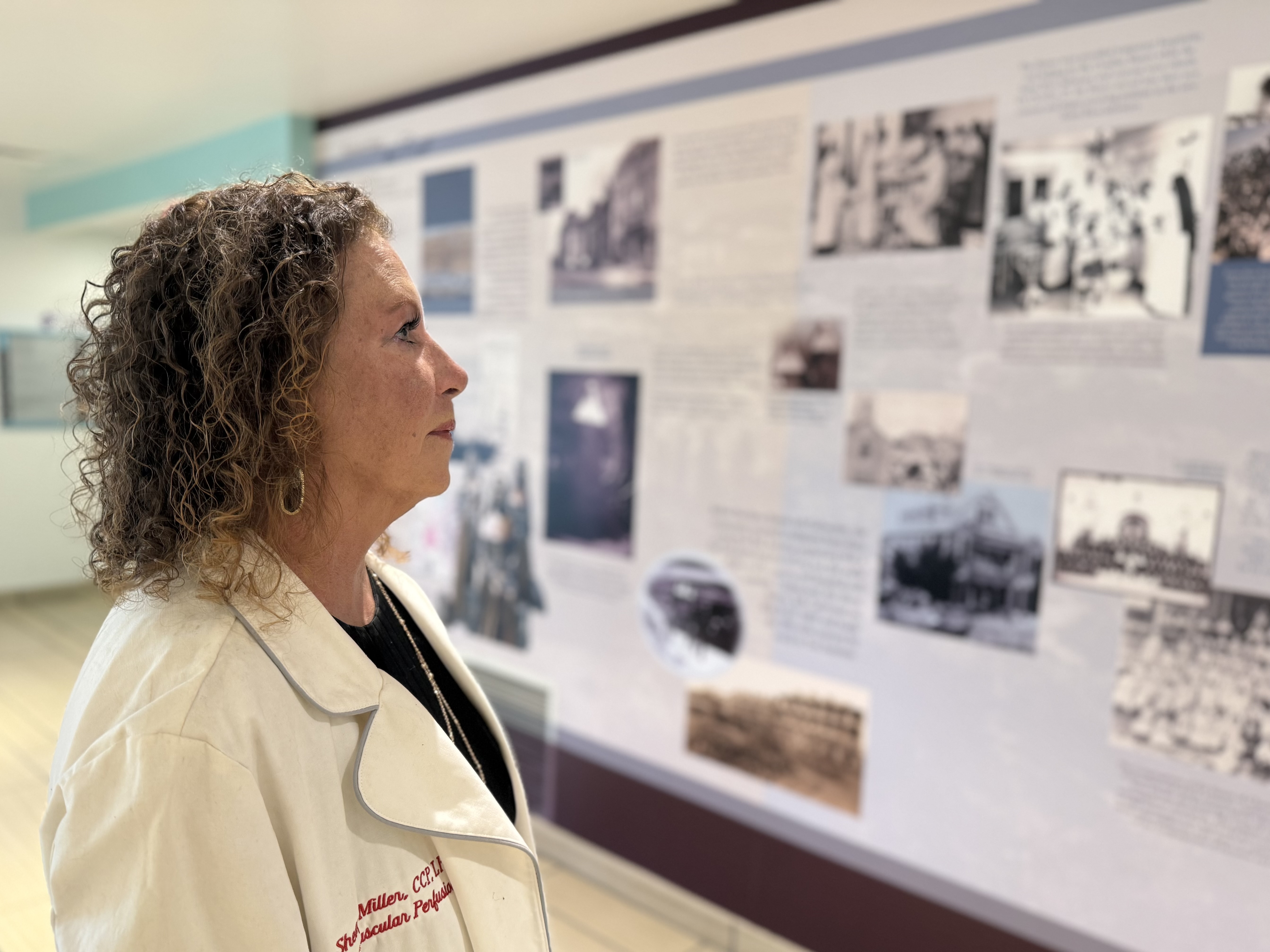 Shelby Maverick Miller viewing a medical history exhibit in her perfusion coat