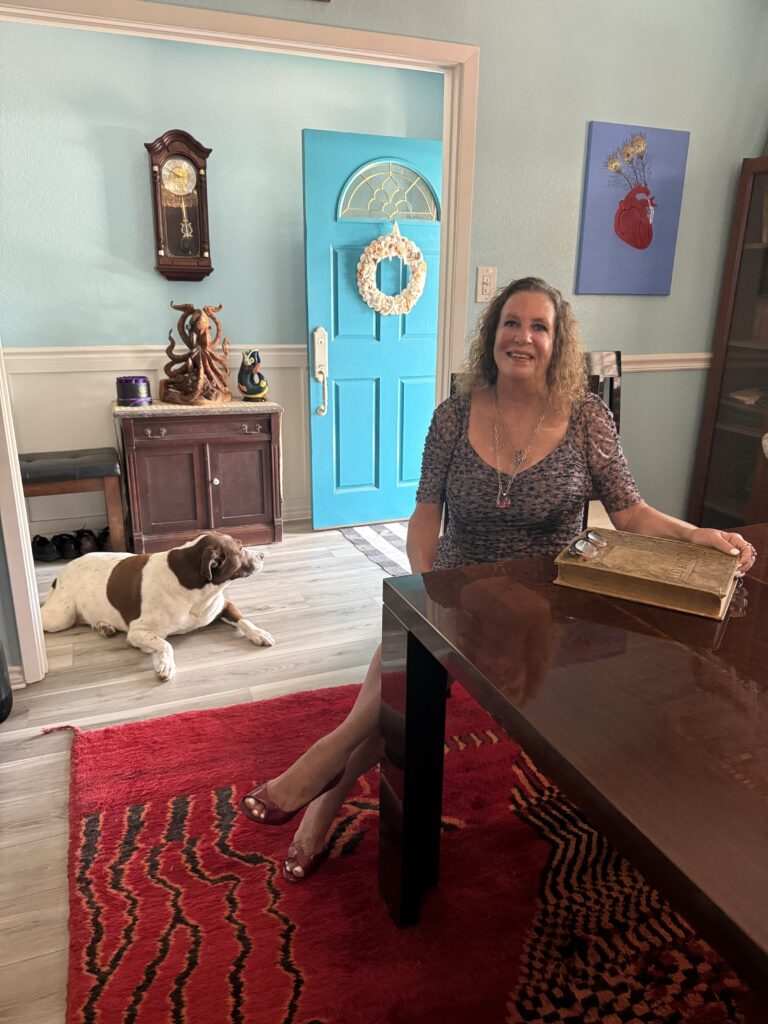 Shelby seated at home with Tucker beside her